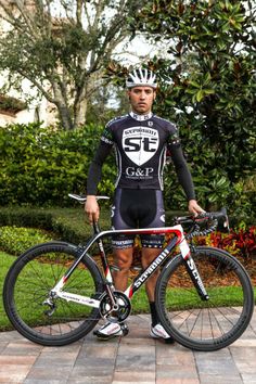 a man is standing next to his bike