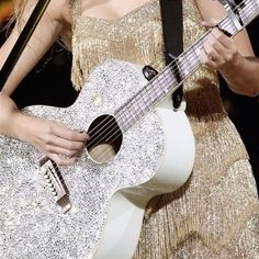 a close up of a person holding a guitar