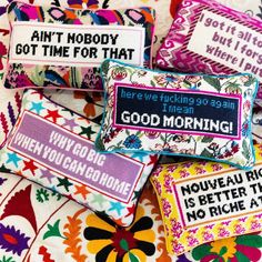 four colorful pillows that have different sayings on them, one says good morning and the other says goodbye