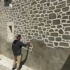 a man is painting the side of a building