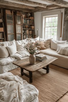 a living room filled with lots of white furniture