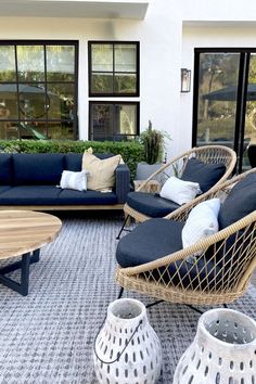 an outdoor living room with wicker furniture