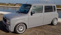 a grey van parked next to a body of water