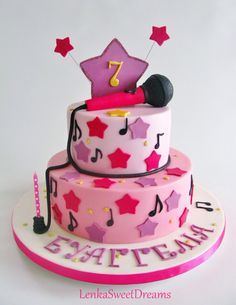 a pink and white cake with musical notes on it