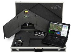 an open briefcase with a laptop and other items in it, including a map on the screen