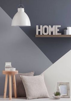 a living room with grey walls and white accents, including a wooden sign that says home on the wall