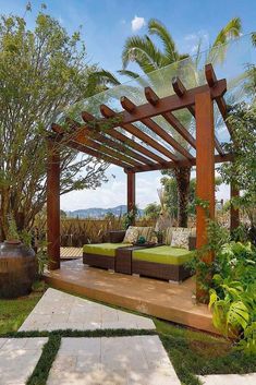 an outdoor living area with green furniture and trees