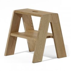 a wooden step stool sitting on top of a white floor