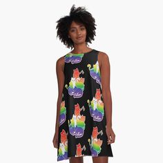 a woman wearing a black dress with colorful cats on it