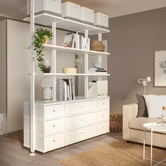 a living room filled with furniture and a white book shelf