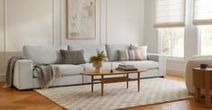 a living room with white walls and wooden floors