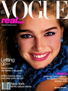 a magazine cover with a woman smiling and wearing blue scarf on the front, featuring an image of her face