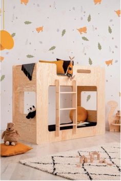 a child's bedroom with an animal themed wallpaper and wooden bunk bed in the corner