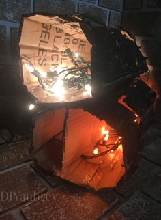 a paper lantern is lit up on the ground