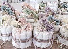 many diapers are stacked on top of each other and decorated with flowers in them