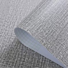 a close up view of a gray fabric with a green line on the bottom half