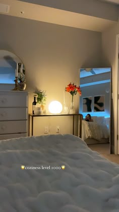 a bedroom with a bed, dresser and mirror in the corner that has flowers on it