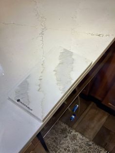 a kitchen counter that has been stripped off and is white with brown spots on it