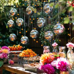 a table topped with lots of different types of food and vases filled with flowers