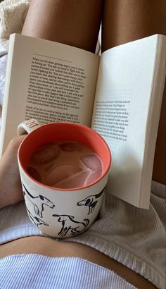 a cup of hot chocolate and an open book