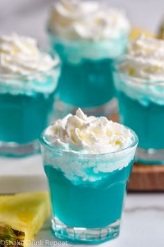 small desserts with blue and white frosting in glass dishes on a counter top