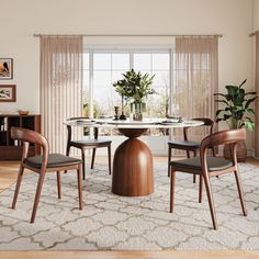 a dining room table with four chairs around it