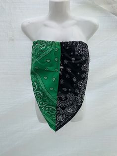 a white mannequin wearing a green and black bandana