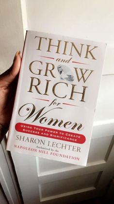 the book think and grow rich for women by sharon lecterr is held in front of a door