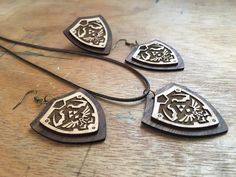 three wooden necklaces sitting on top of a table