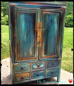 an old armoire painted in blue and green