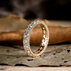 a wedding ring sitting on top of a wooden table