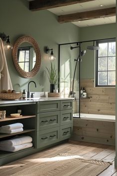 a bathroom with green walls and wooden floors, along with a large mirror on the wall