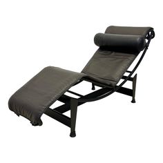 the reclining chair is black and has an ottoman on it's back end