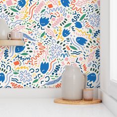 a colorful wallpaper with birds and flowers on it in a kitchen area next to a window