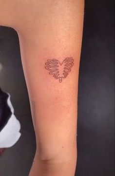 a woman's arm with a small tattoo on the left side of her leg