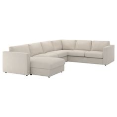 a white sectional couch sitting on top of a white floor