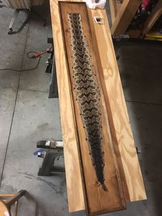 a fish is laying on top of a piece of wood in the process of being built