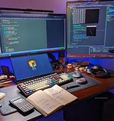 two computer monitors sitting on top of a desk next to a keyboard and mouses