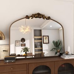 a large mirror sitting on top of a wooden dresser