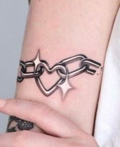 a woman's arm with a chain tattoo on it