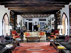 a living room filled with furniture and lots of books