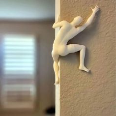 there is a small white figurine on the wall