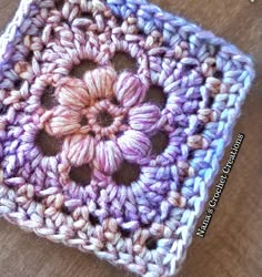 a crocheted square with a flower on it