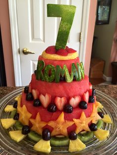 a watermelon cake with the number seven on top