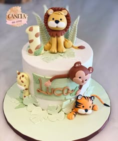 a birthday cake decorated with animals and letters