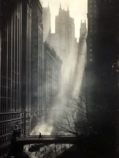 an old photo of a city with skyscrapers in the background and mist rising from the ground