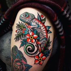 a lizard with flowers and leaves on his arm