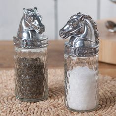 two salt and pepper shakers sitting on top of a table