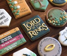 decorated cookies with the lord of the rings written on them are arranged on a table