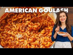 a woman holding a plate with pasta in it and the words american goulash